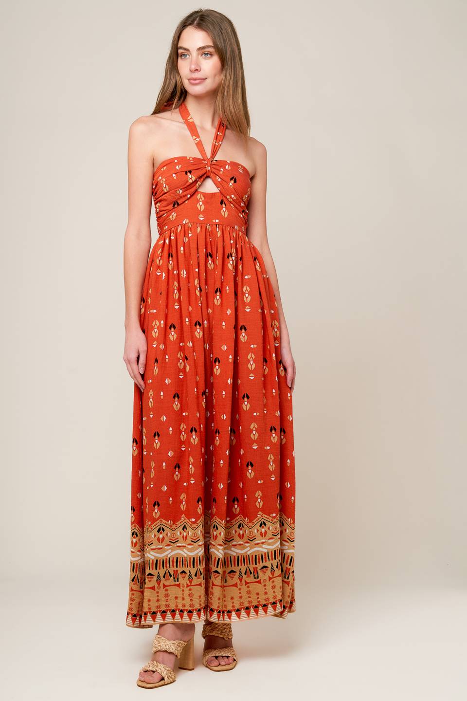 A printed woven maxi dress featuring halter neckline, center front cut out, wide waistband and smocked back bodies.