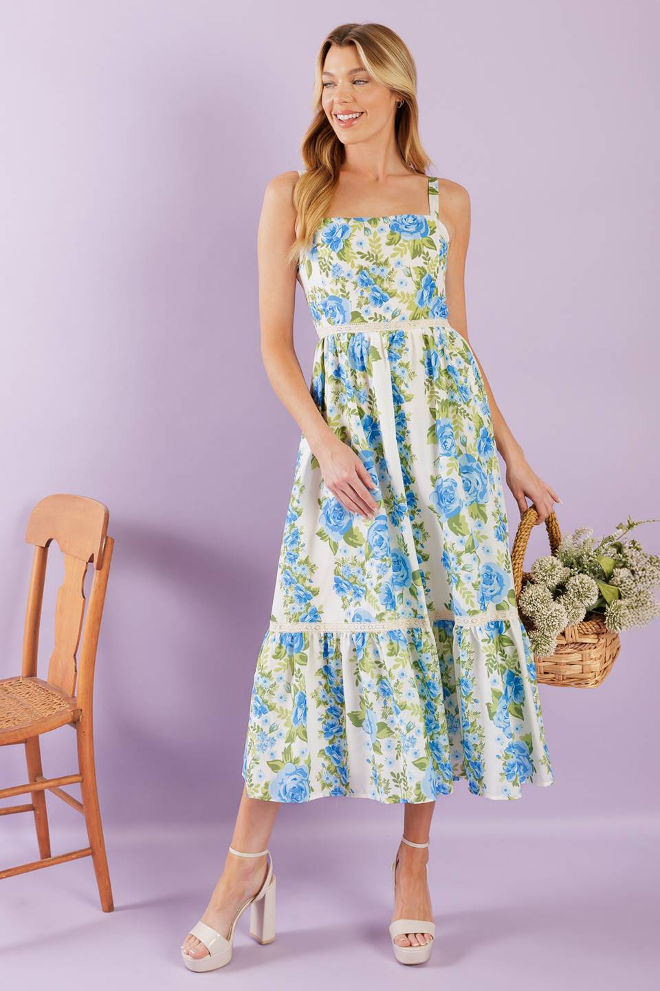 A woven midi dress printed with a straight neckline, straps, lace contrast, ruffled hemline and smocked back bodice.