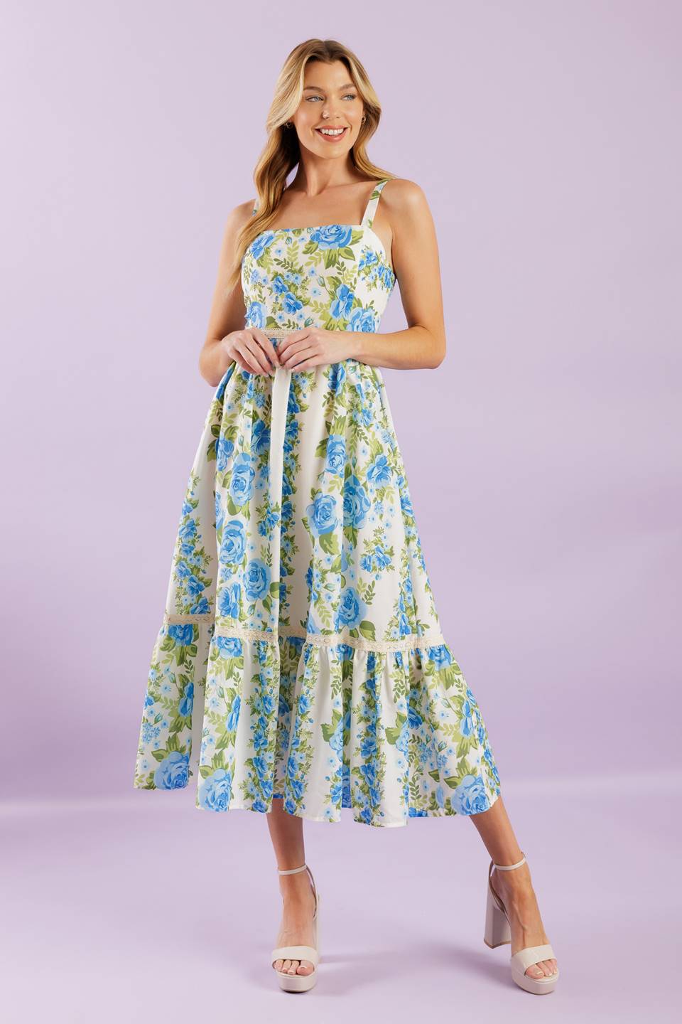 A woven midi dress printed with a straight neckline, straps, lace contrast, ruffled hemline and smocked back bodice.