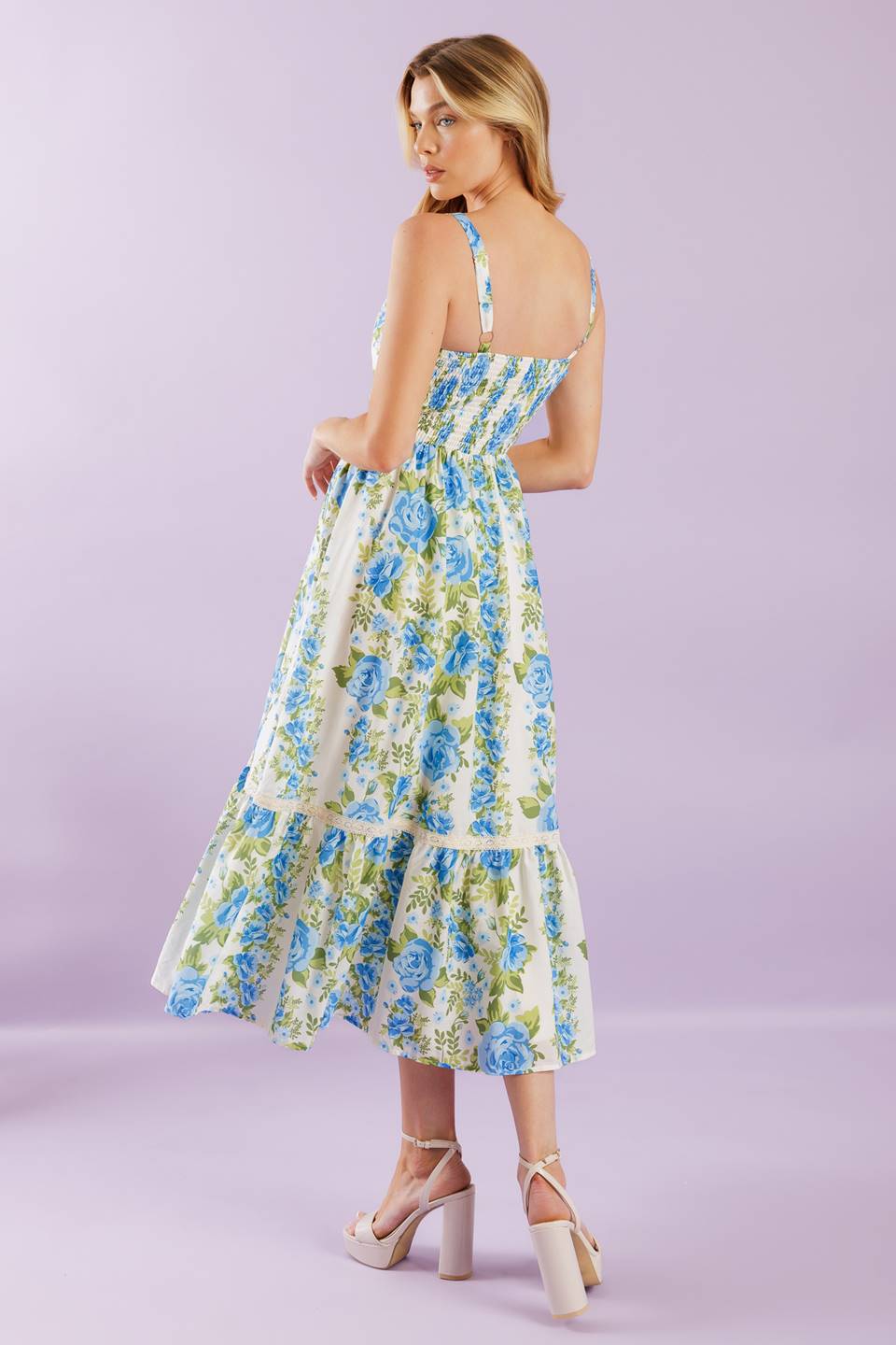 A woven midi dress printed with a straight neckline, straps, lace contrast, ruffled hemline and smocked back bodice.