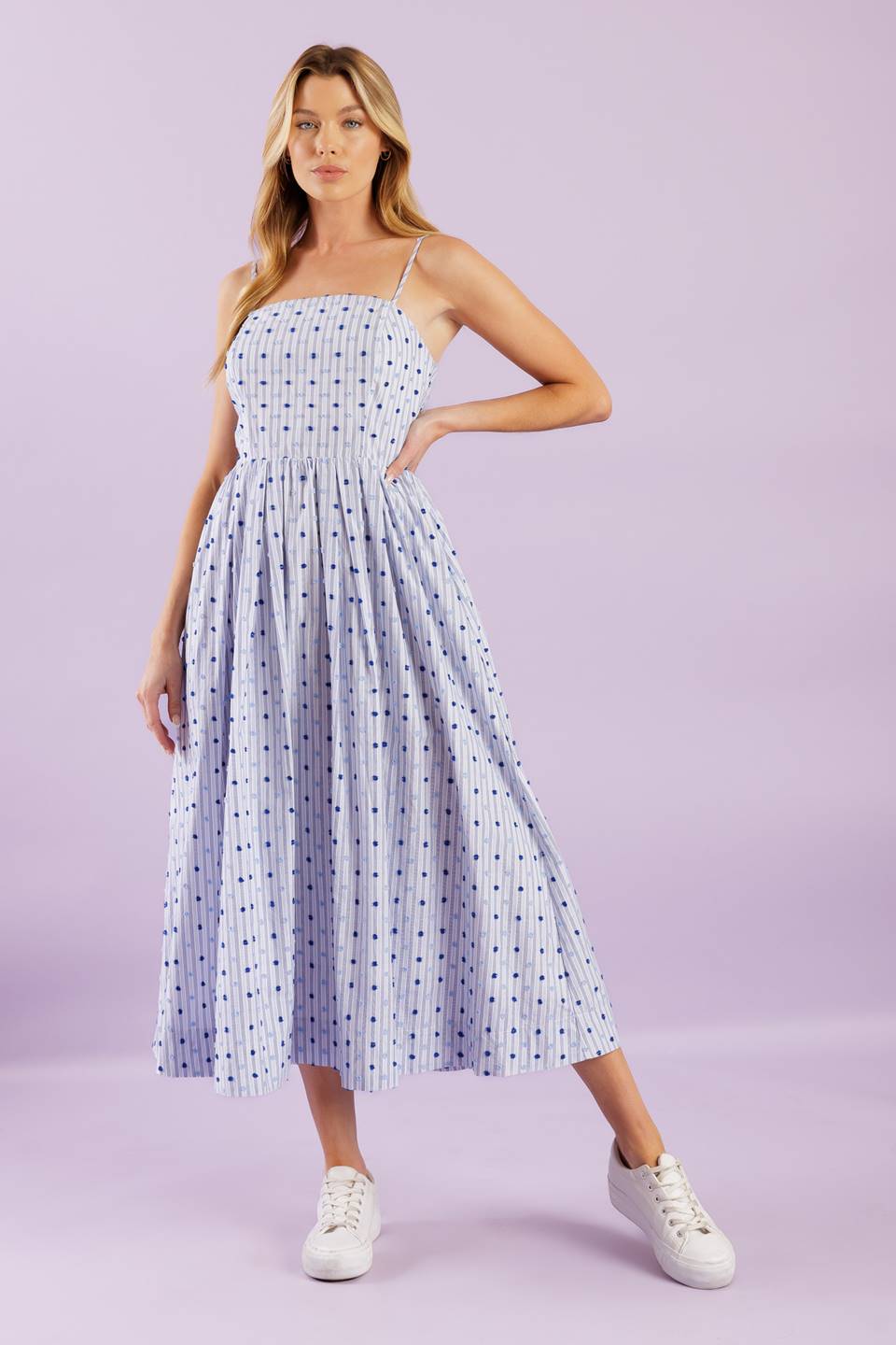 This woven midi dress boasts a textured striped design with a straight neckline, adjustable straps, a full skirt, and a back zipper closure for effortless wear.