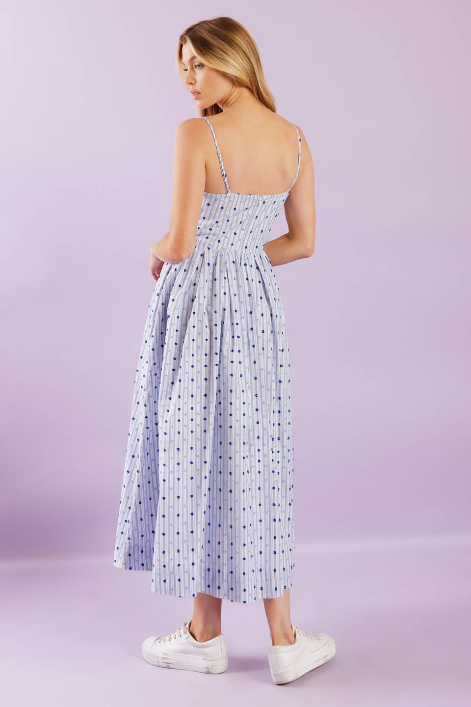 This woven midi dress boasts a textured striped design with a straight neckline, adjustable straps, a full skirt, and a back zipper closure for effortless wear.