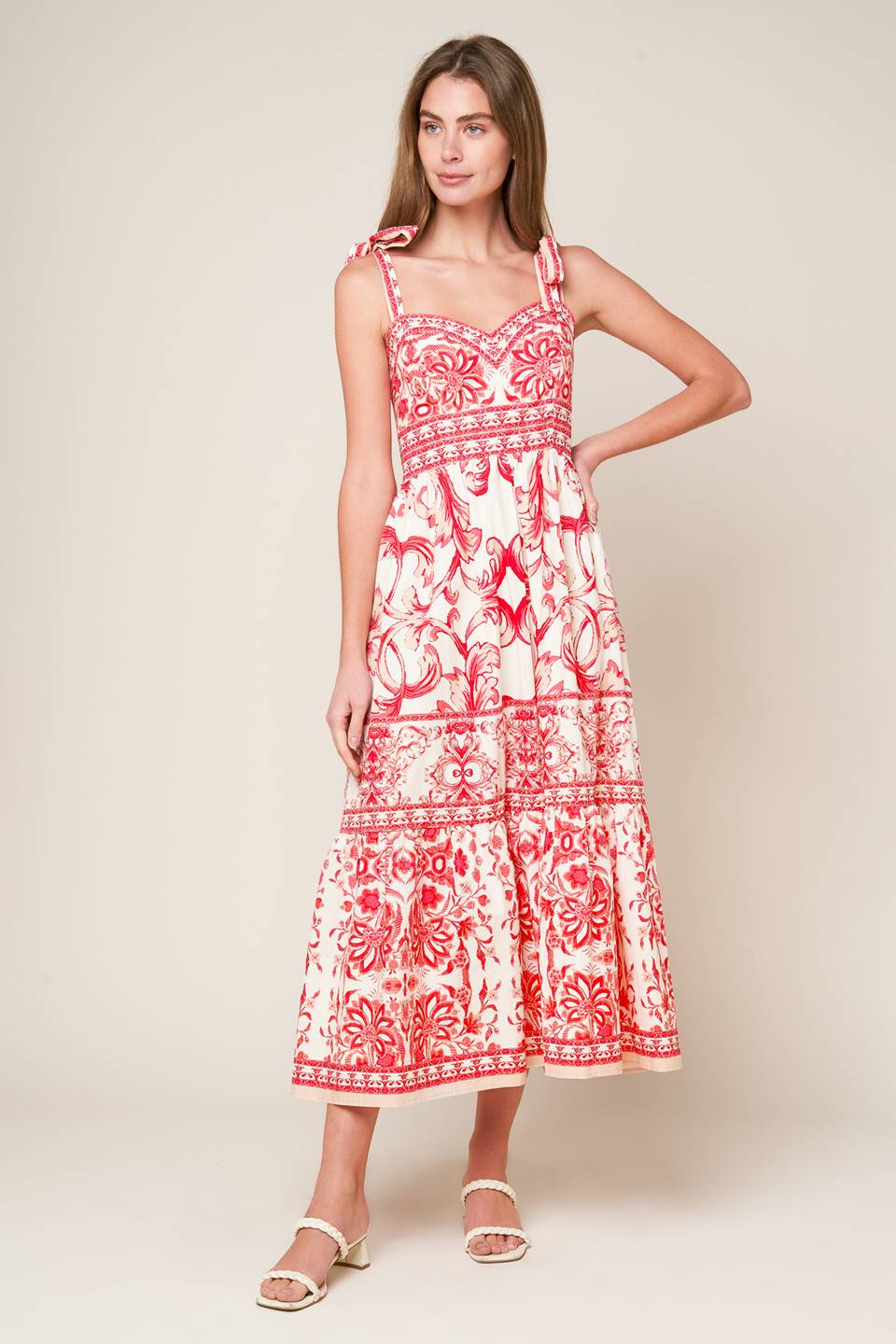 A printed woven midi dress featuring sweetheart neckline, shoulder ties, ruffled hemline and smocked back bodice