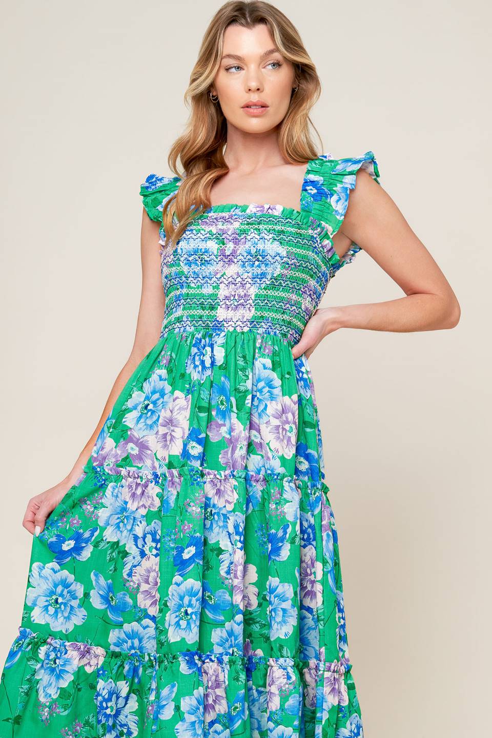 A printed woven midi dress featuring square neckline, ruffled sleeve, smocked bodice, tiered skirt.