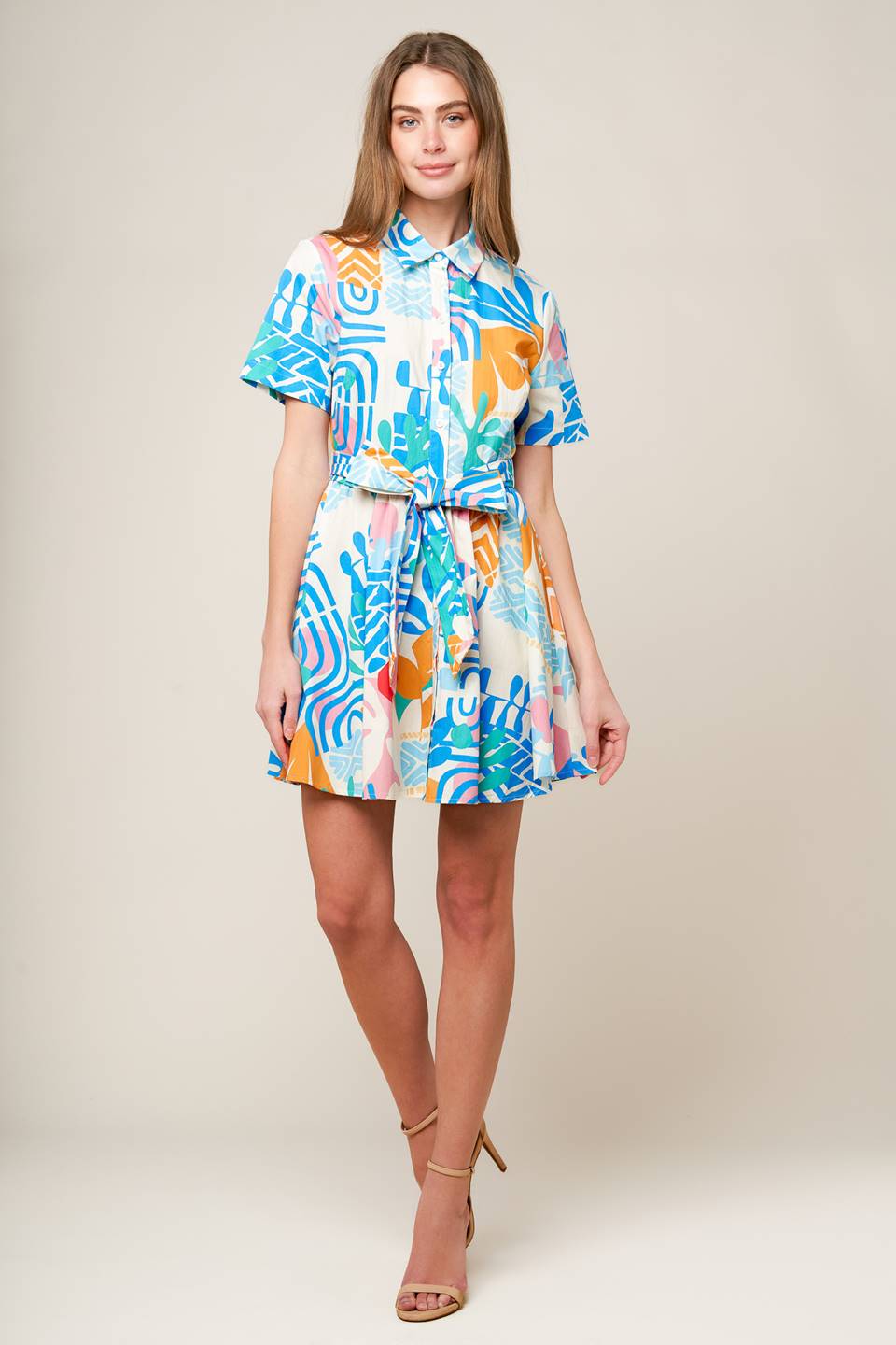 A printed woven mini dress featuring collar, button down, short sleeve and self sash tie