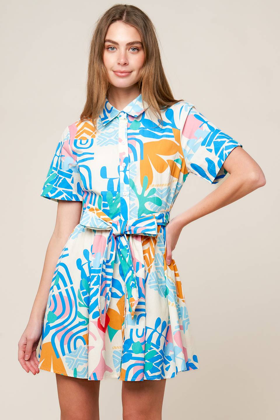 A printed woven mini dress featuring collar, button down, short sleeve and self sash tie