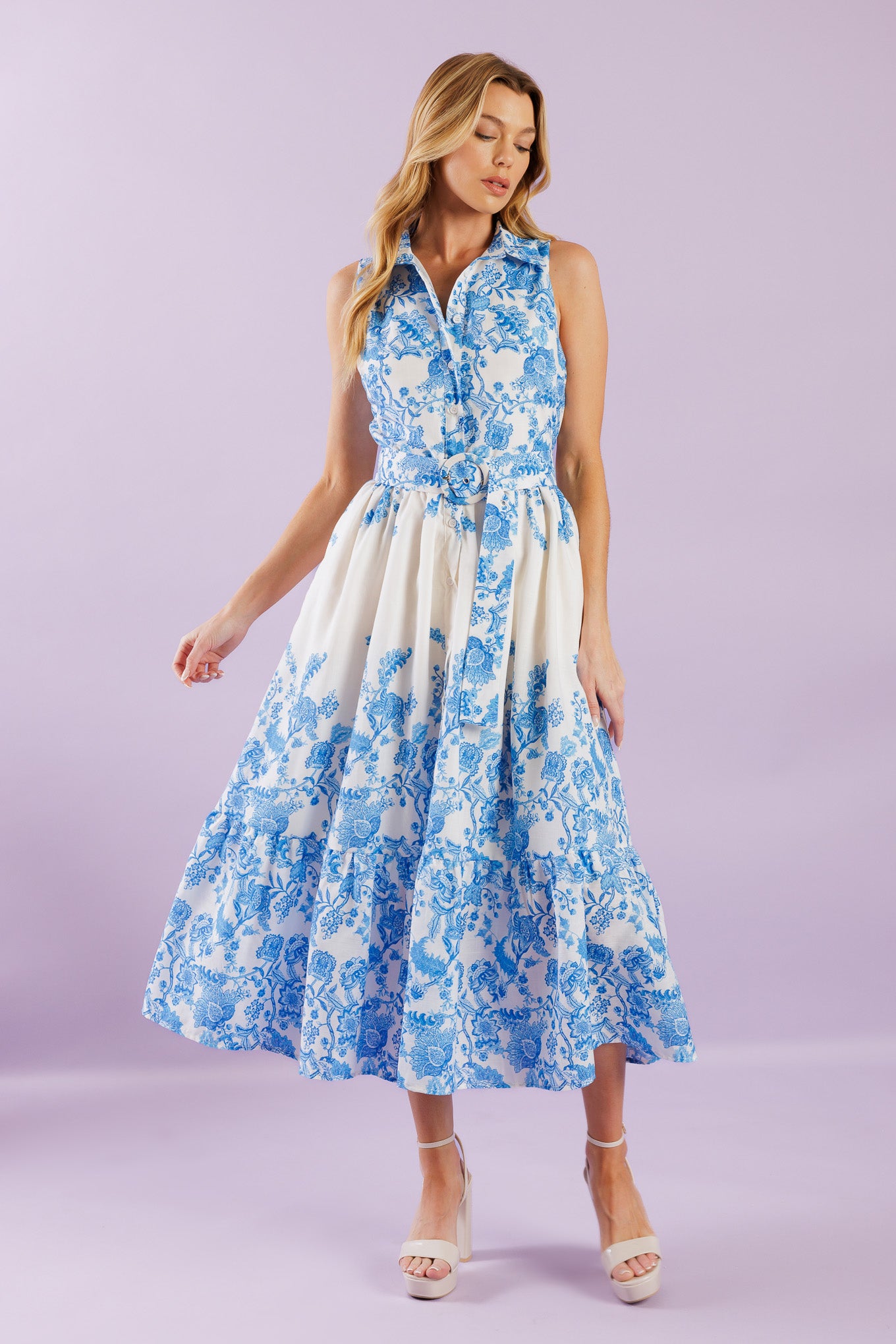 Elevate your vacation style with our Palm Shores Woven Midi Dress. This printed dress features a shirt collar, sleeveless design, and a flattering button-down front. The self belt cinches in your waist, while the full skirt with a ruffled hemline adds a touch of femininity.


Details:

Self : 100% Polyester
Lining : 100% Polyester

Size &amp; Fit

- Model is 5`8" And Wearing Size Small
- Measurements Taken From Size Small
- Approx. Length: 53" FLYING TOMATO