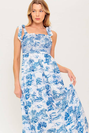 A printed woven midi dress featuring sweetheart neckline, shoulder ties, smocked bodice and tiered skirt