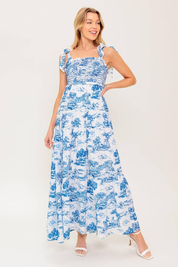 A printed woven midi dress featuring sweetheart neckline, shoulder ties, smocked bodice and tiered skirt