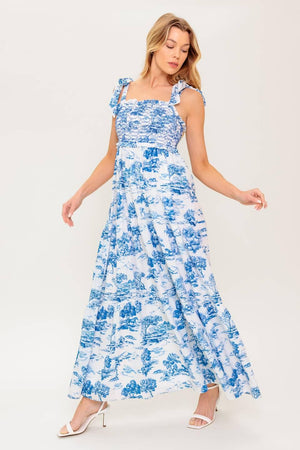 A printed woven midi dress featuring sweetheart neckline, shoulder ties, smocked bodice and tiered skirt