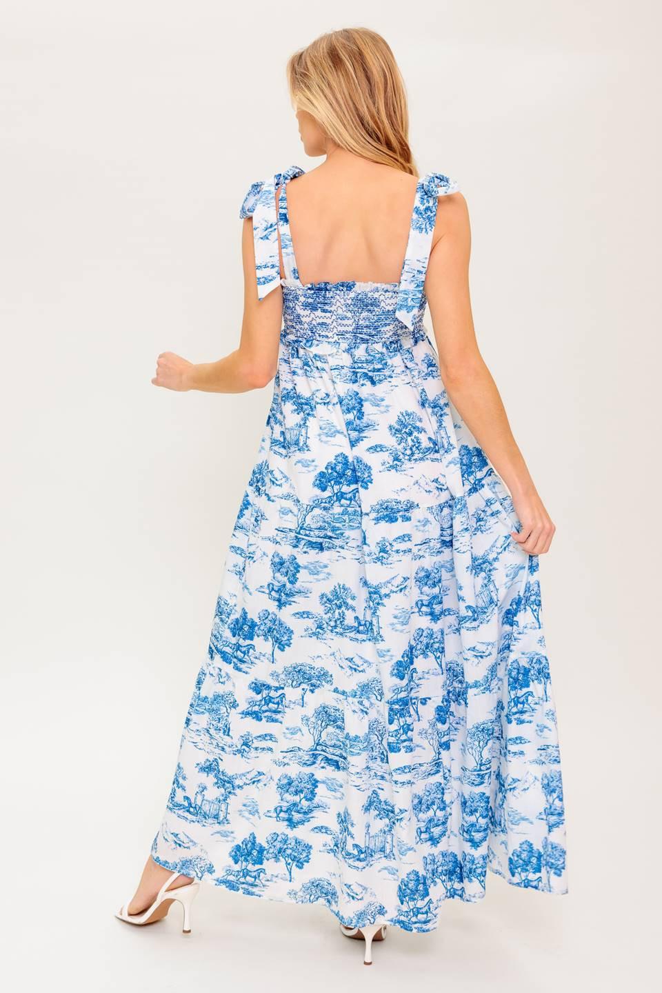 A printed woven midi dress featuring sweetheart neckline, shoulder ties, smocked bodice and tiered skirt