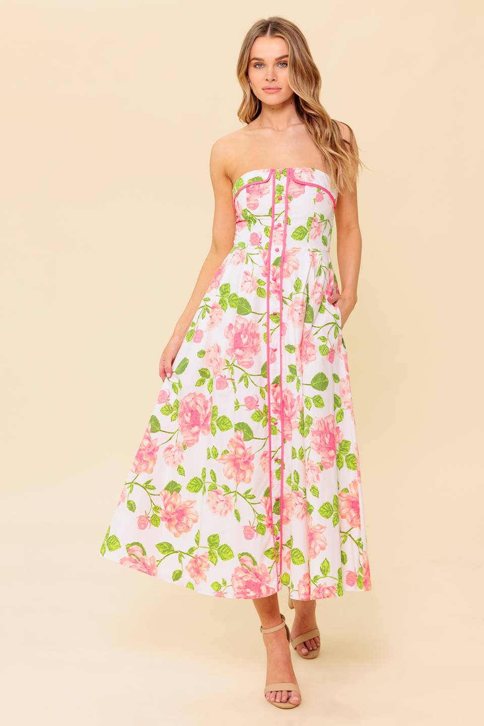 A floral printed, strapless, woven midi dress featuring button down detail, full skirt and back zipper closure