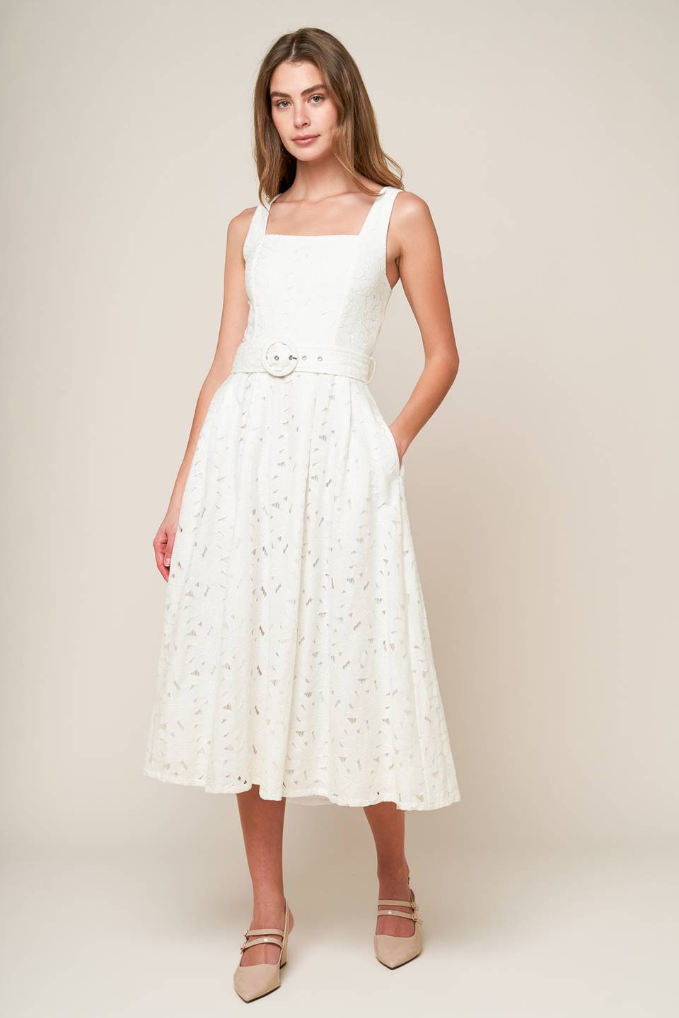 A woven lace midi dress featuring square neckline, sleeveless, self belt, full skirt and back zipper closure