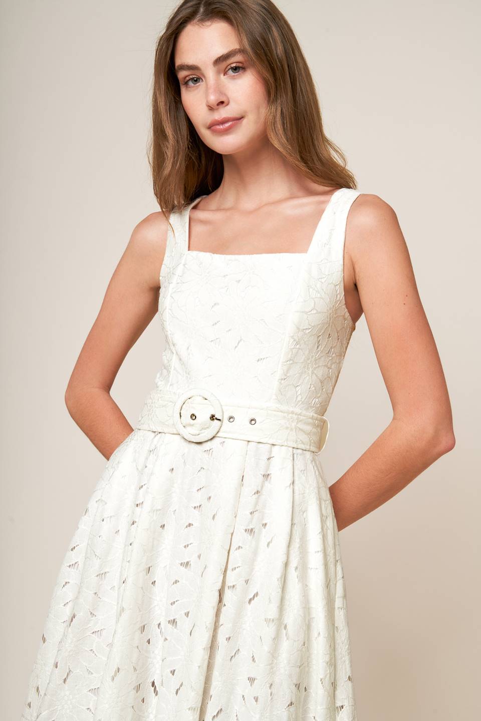 A woven lace midi dress featuring square neckline, sleeveless, self belt, full skirt and back zipper closure