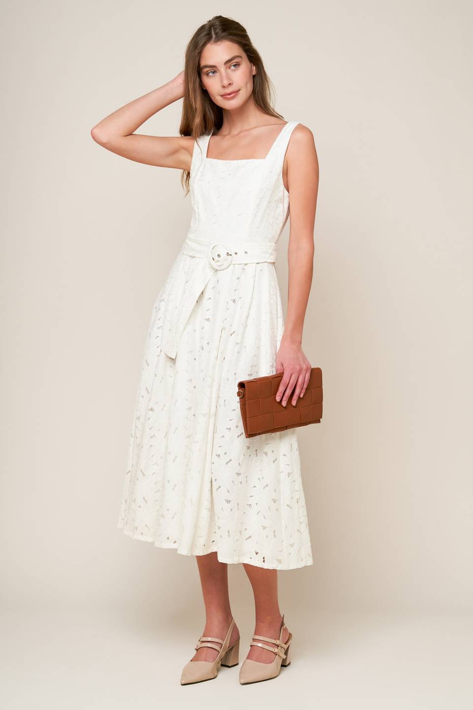 A woven lace midi dress featuring square neckline, sleeveless, self belt, full skirt and back zipper closure