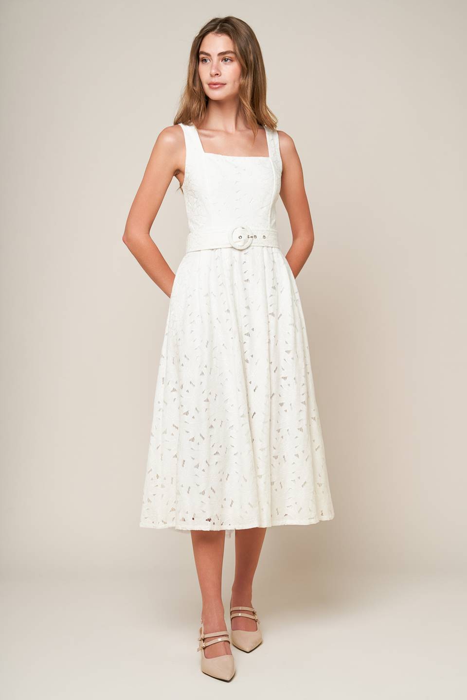 A woven lace midi dress featuring square neckline, sleeveless, self belt, full skirt and back zipper closure