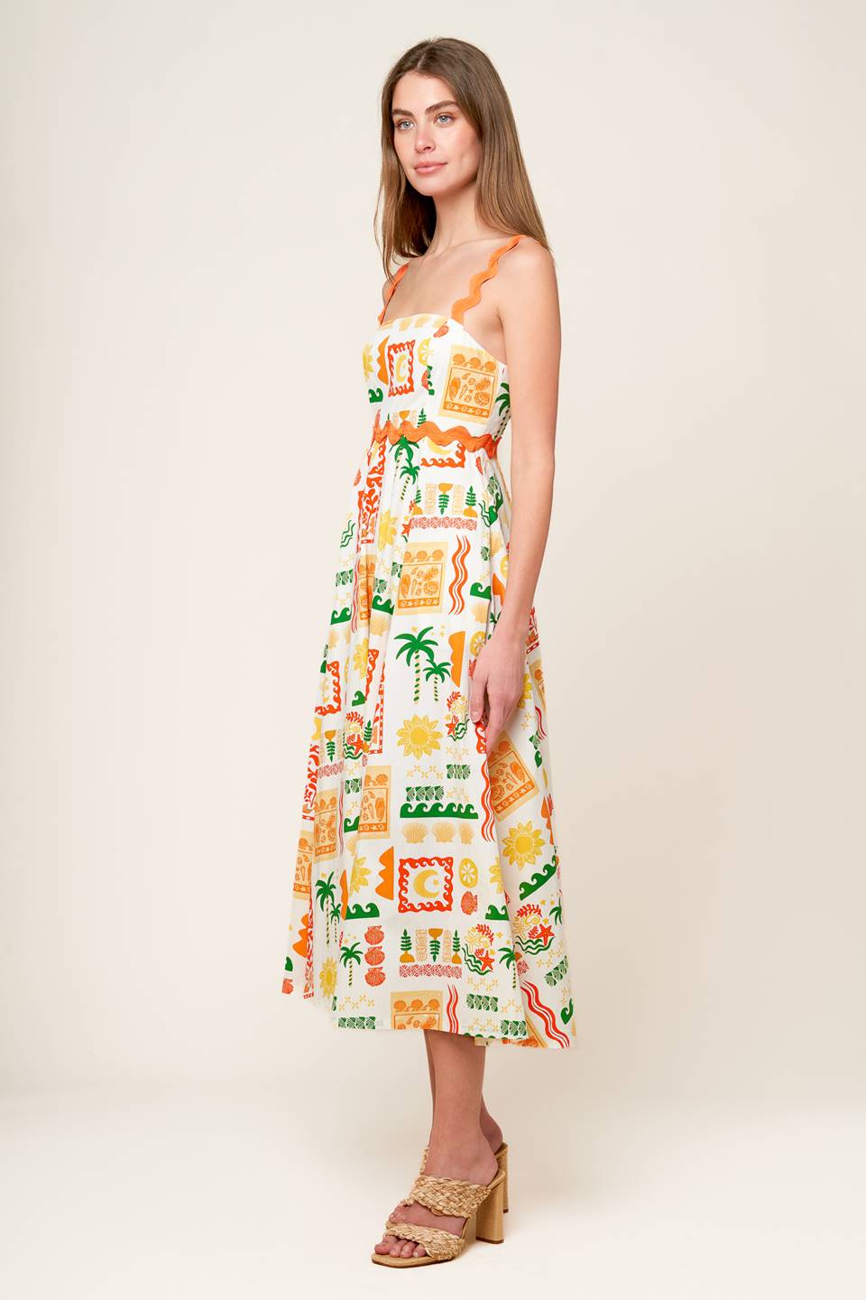 A printed woven midi dress featuring straight neckline, ric rac ribbon trim and strap, circle skirt and back zipper closure.