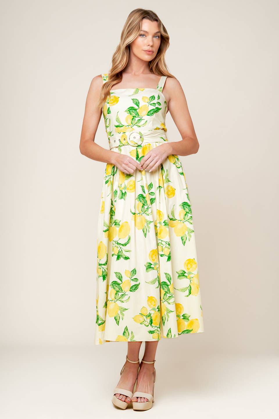 A printed woven midi dress featuring straight neckline, straps, self belt, full skirt and back zipper closure.