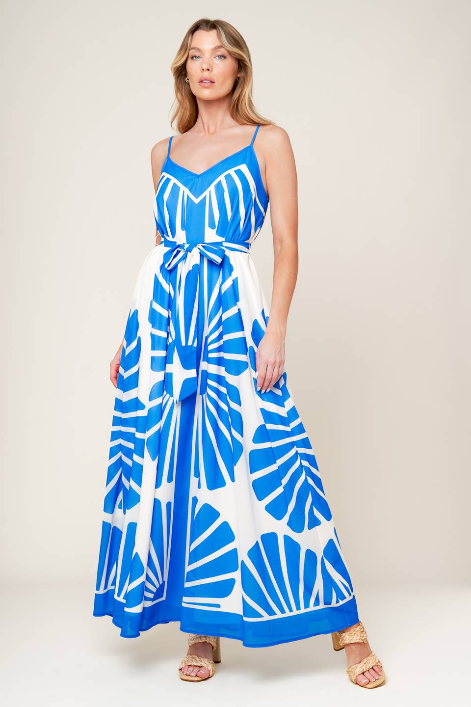 A white and blue printed woven maxi dress featuring cami top, self sash and relaxed body.