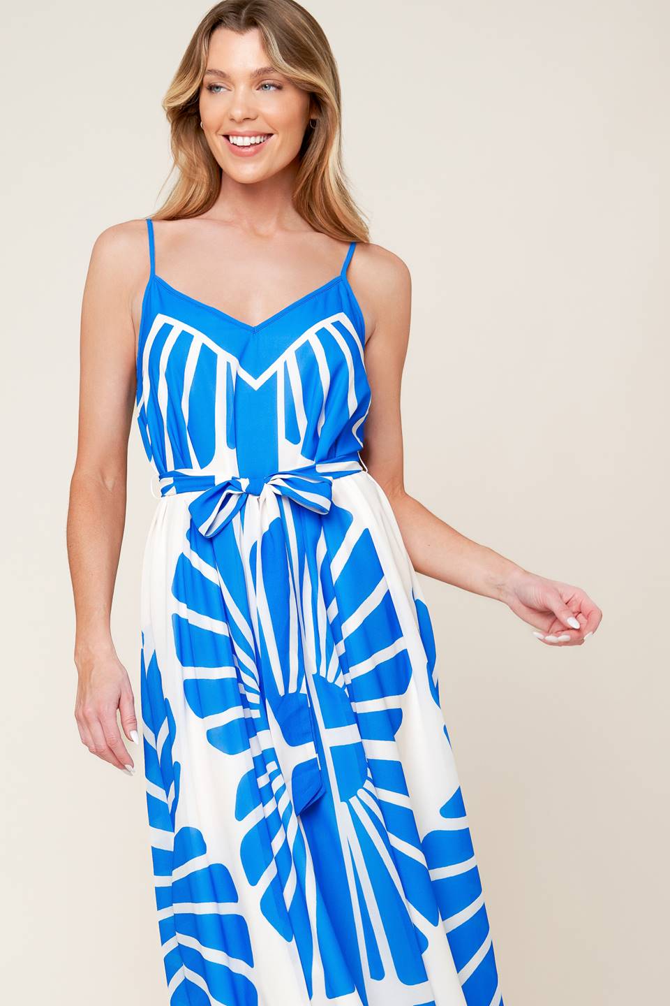 A white and blue printed woven maxi dress featuring cami top, self sash and relaxed body.