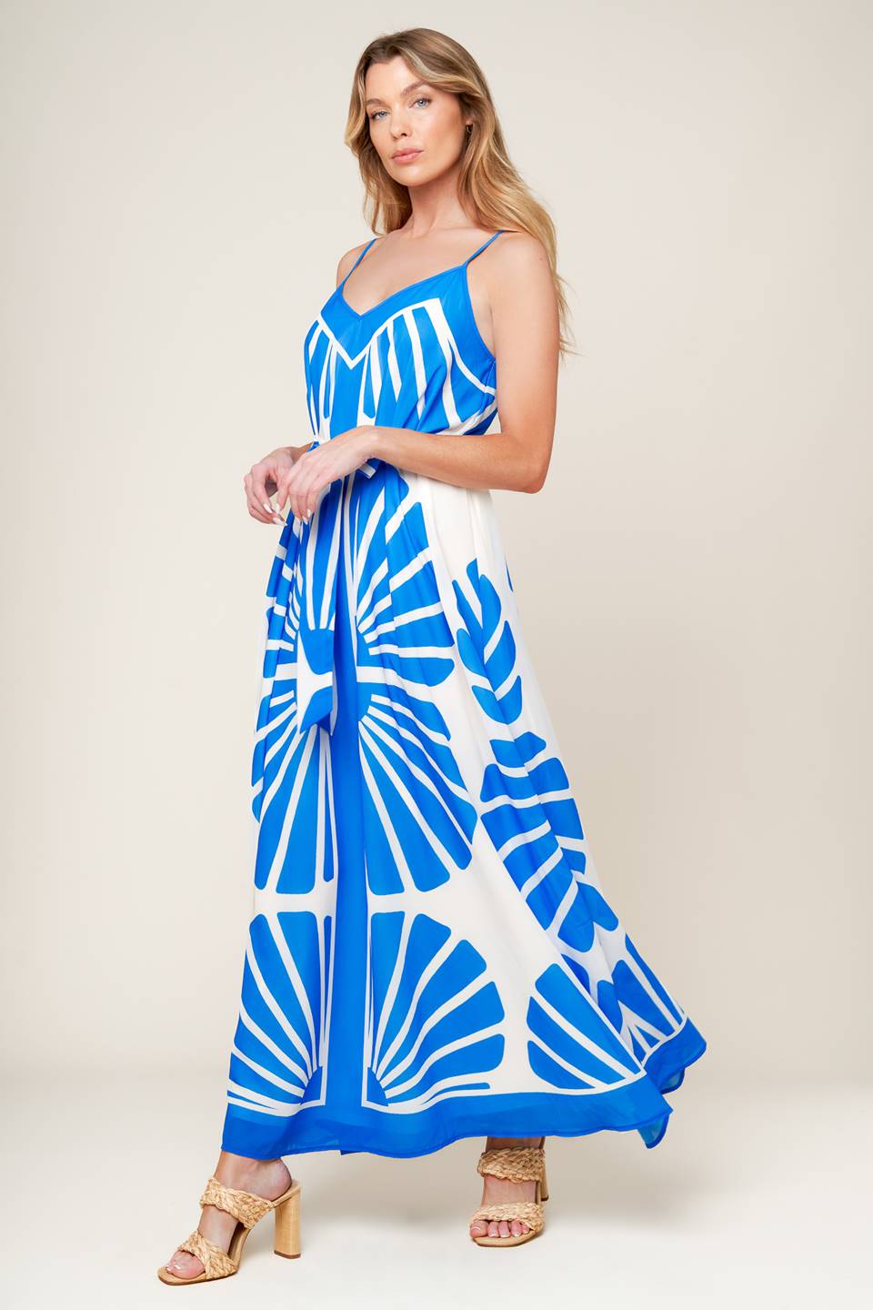 A white and blue printed woven maxi dress featuring cami top, self sash and relaxed body.