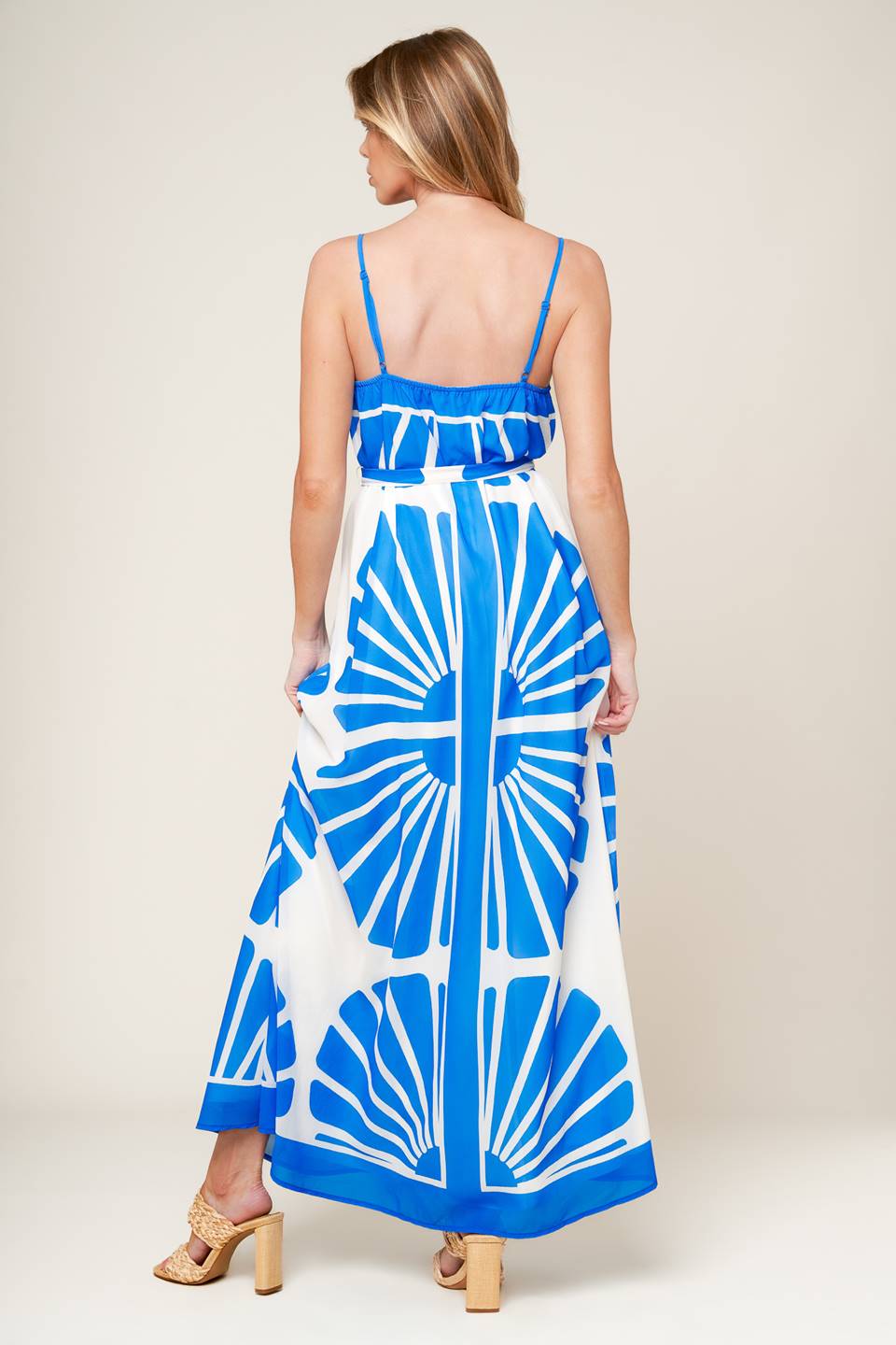 A white and blue printed woven maxi dress featuring cami top, self sash and relaxed body.