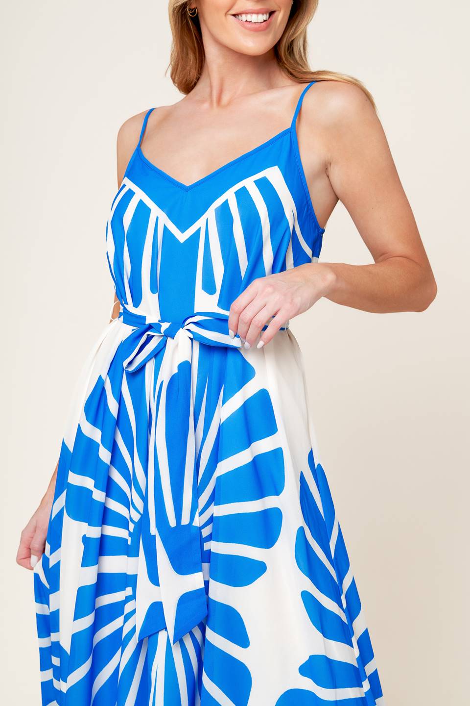 A white and blue printed woven maxi dress featuring cami top, self sash and relaxed body.