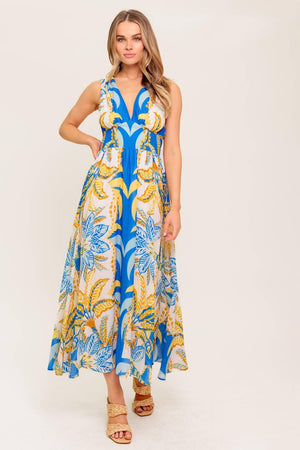 A printed woven midi dress featuring V neckline, sleeveless, waist yoke, full skirt and smocked back waistband.