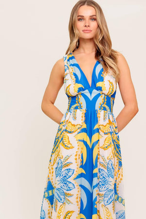 A printed woven midi dress featuring V neckline, sleeveless, waist yoke, full skirt and smocked back waistband.