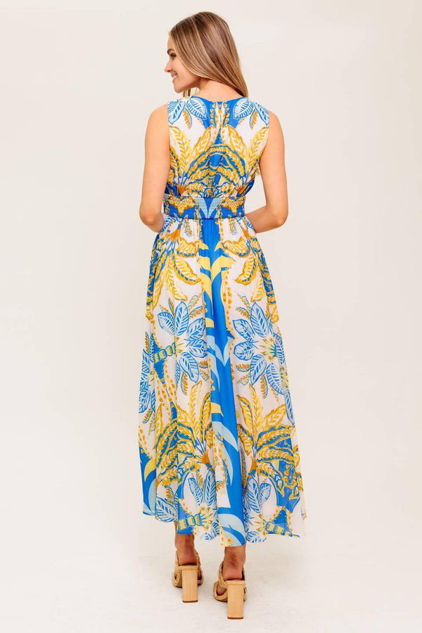 A printed woven midi dress featuring V neckline, sleeveless, waist yoke, full skirt and smocked back waistband.