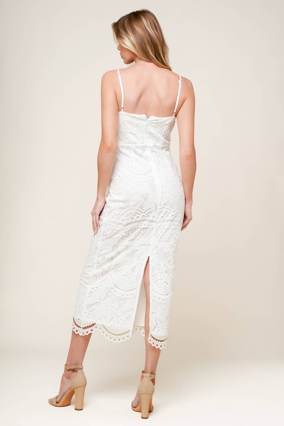 A white woven lace midi dress featuring sweetheart neckline, straps and back zipper closure.