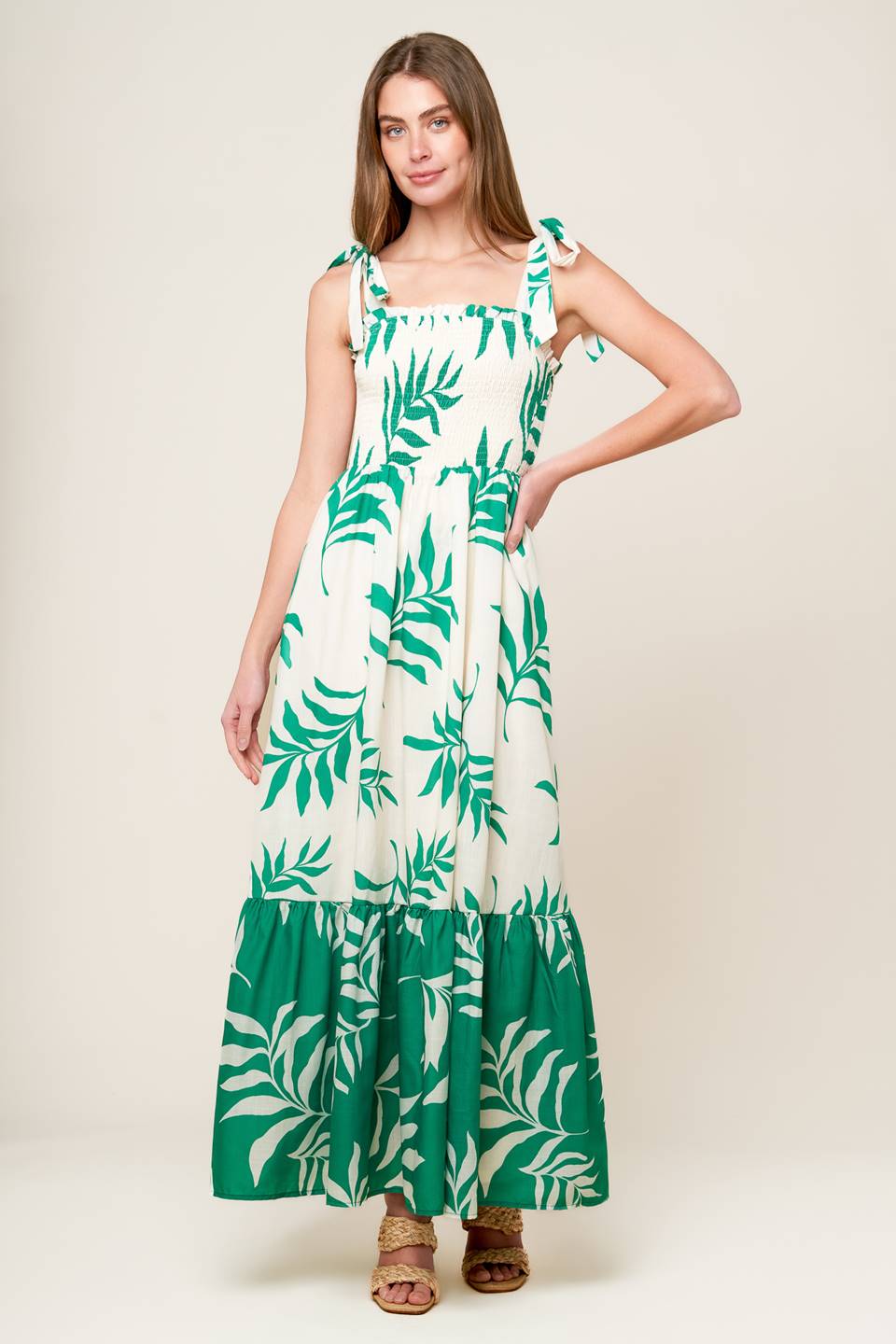 A printed woven maxi dress featuring straight neckline with ruffled edge, shoulder ties, smocked bodice and ruffled hemline.