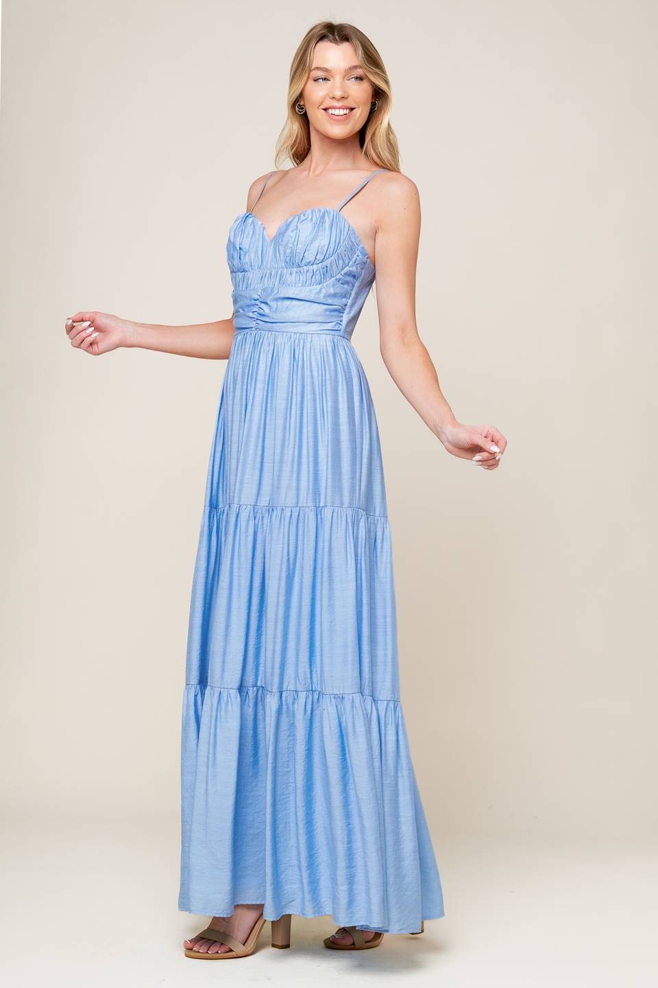 A light blue solid woven maxi dress featuring sweetheart neckline with straps, ruched bodice, tiered skirt and back zipper closure.