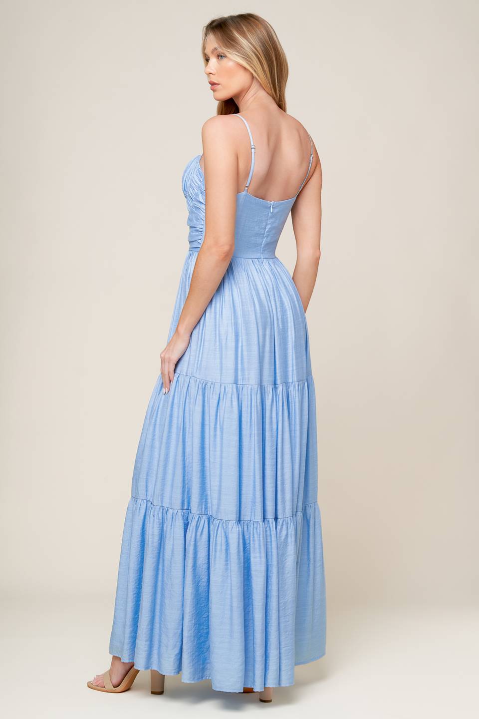 A light blue solid woven maxi dress featuring sweetheart neckline with straps, ruched bodice, tiered skirt and back zipper closure.