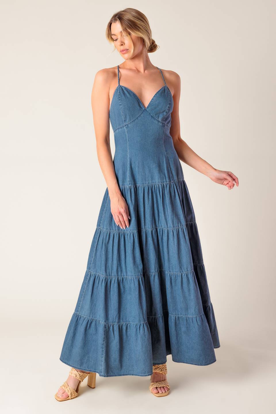 A chambray midi dress featuring cami top, fitted waistline, tiered skirt, bare back with O ring and straps and zipper closure.