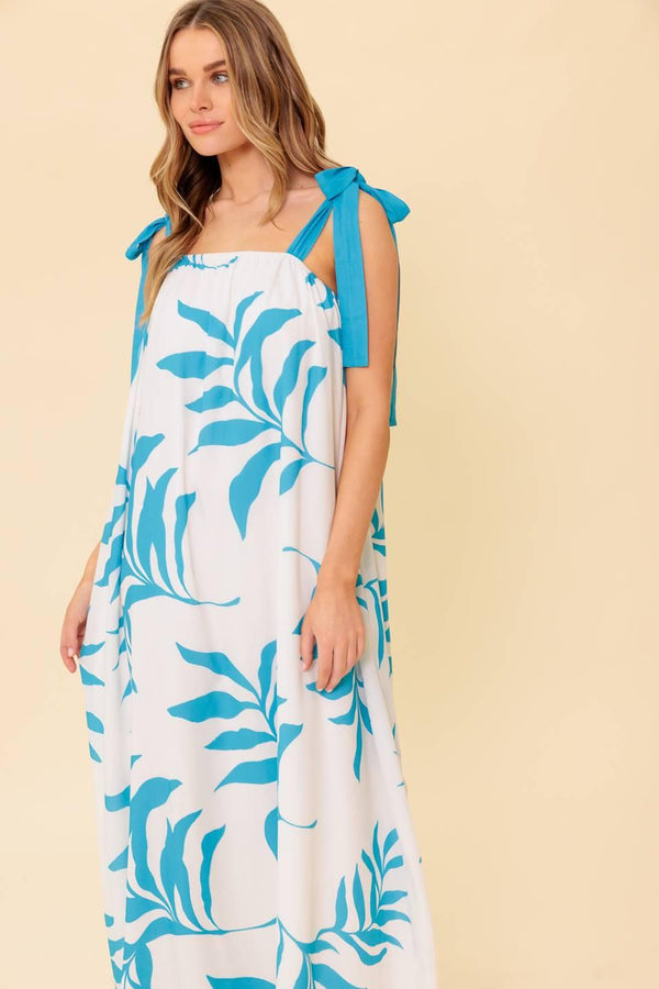 A printed woven maxi dress featuring straight neckline, shoulder tie and plunging back