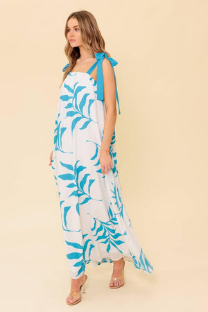 A printed woven maxi dress featuring straight neckline, shoulder tie and plunging back