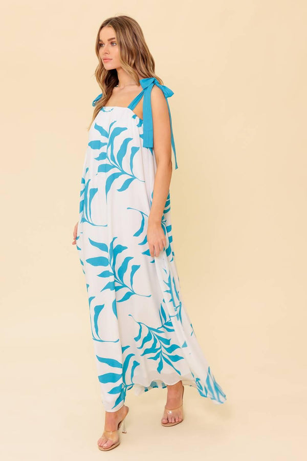 A printed woven maxi dress featuring straight neckline, shoulder tie and plunging back