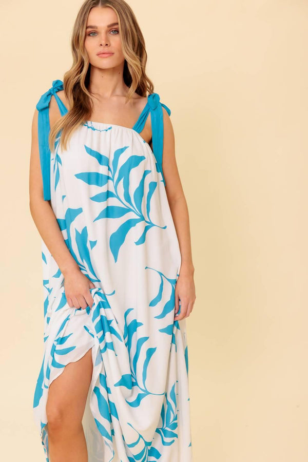 A printed woven maxi dress featuring straight neckline, shoulder tie and plunging back
