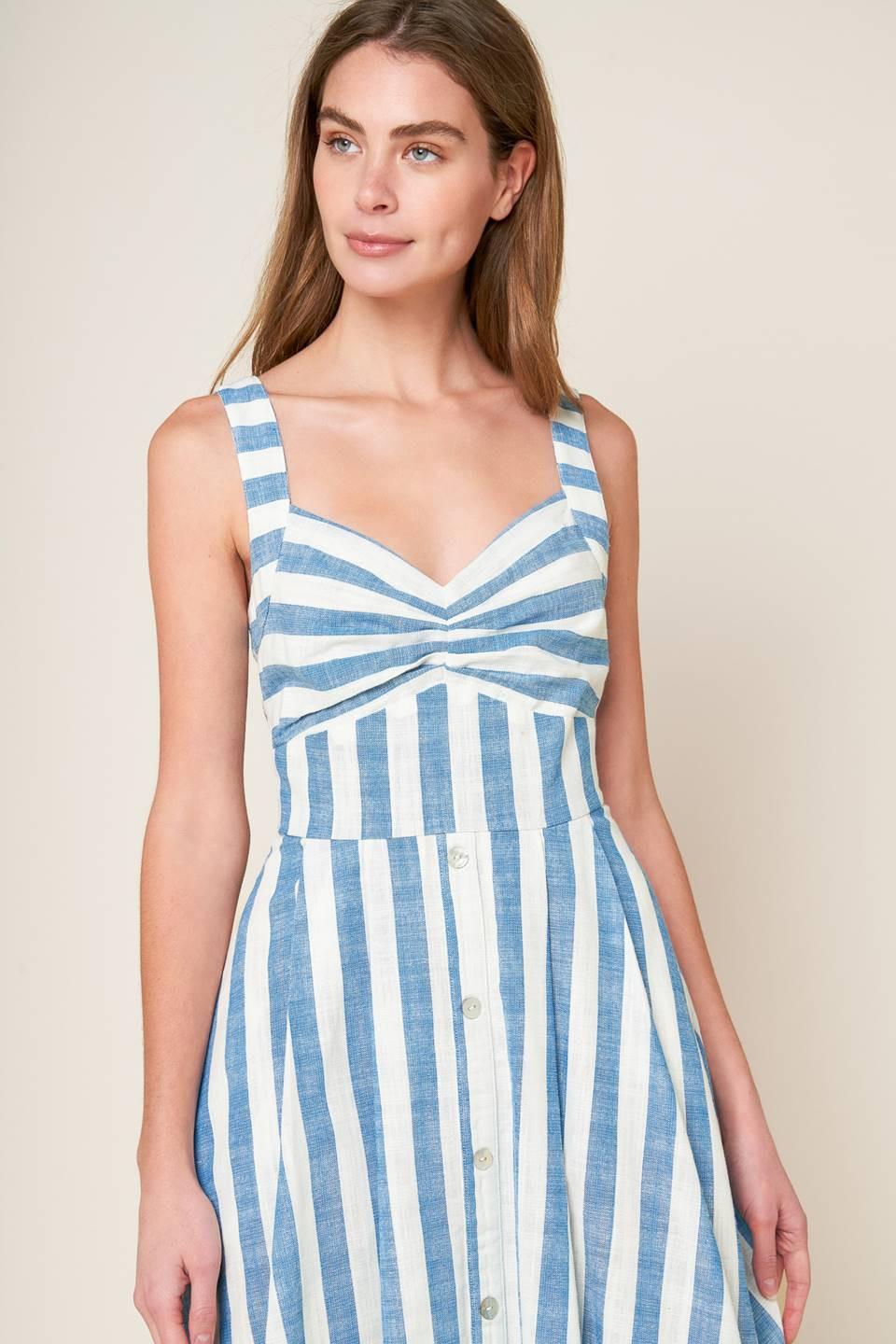 A white and blue striped woven midi dress featuring V neckline, cinched bust center, waist yoke and back zipper closure.