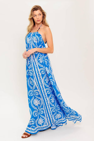 A printed woven maxi dress featuring halter neckline, trimmed tie and plunging back