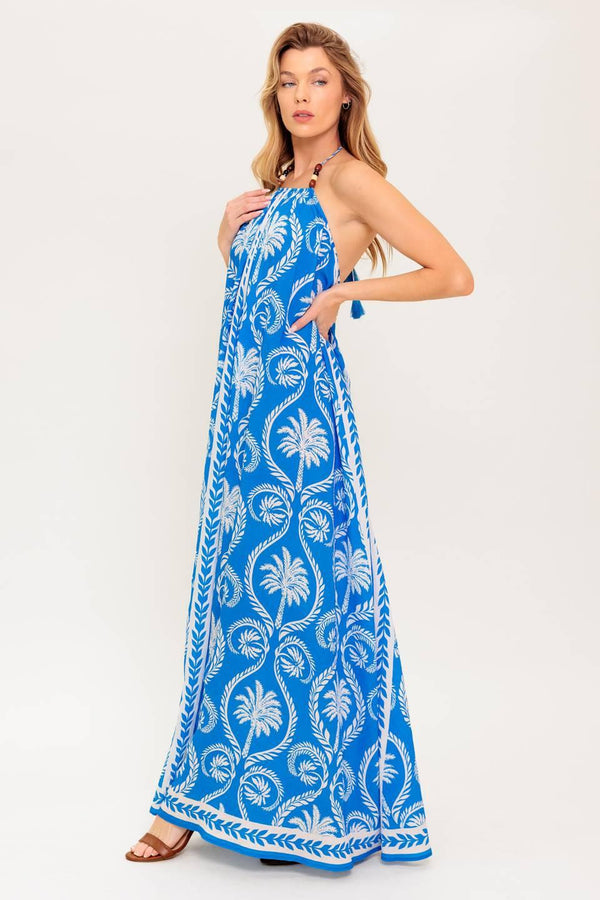 A printed woven maxi dress featuring halter neckline, trimmed tie and plunging back