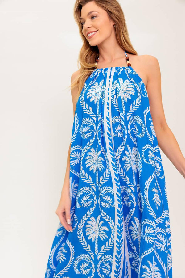 A printed woven maxi dress featuring halter neckline, trimmed tie and plunging back