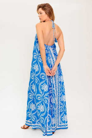 A printed woven maxi dress featuring halter neckline, trimmed tie and plunging back