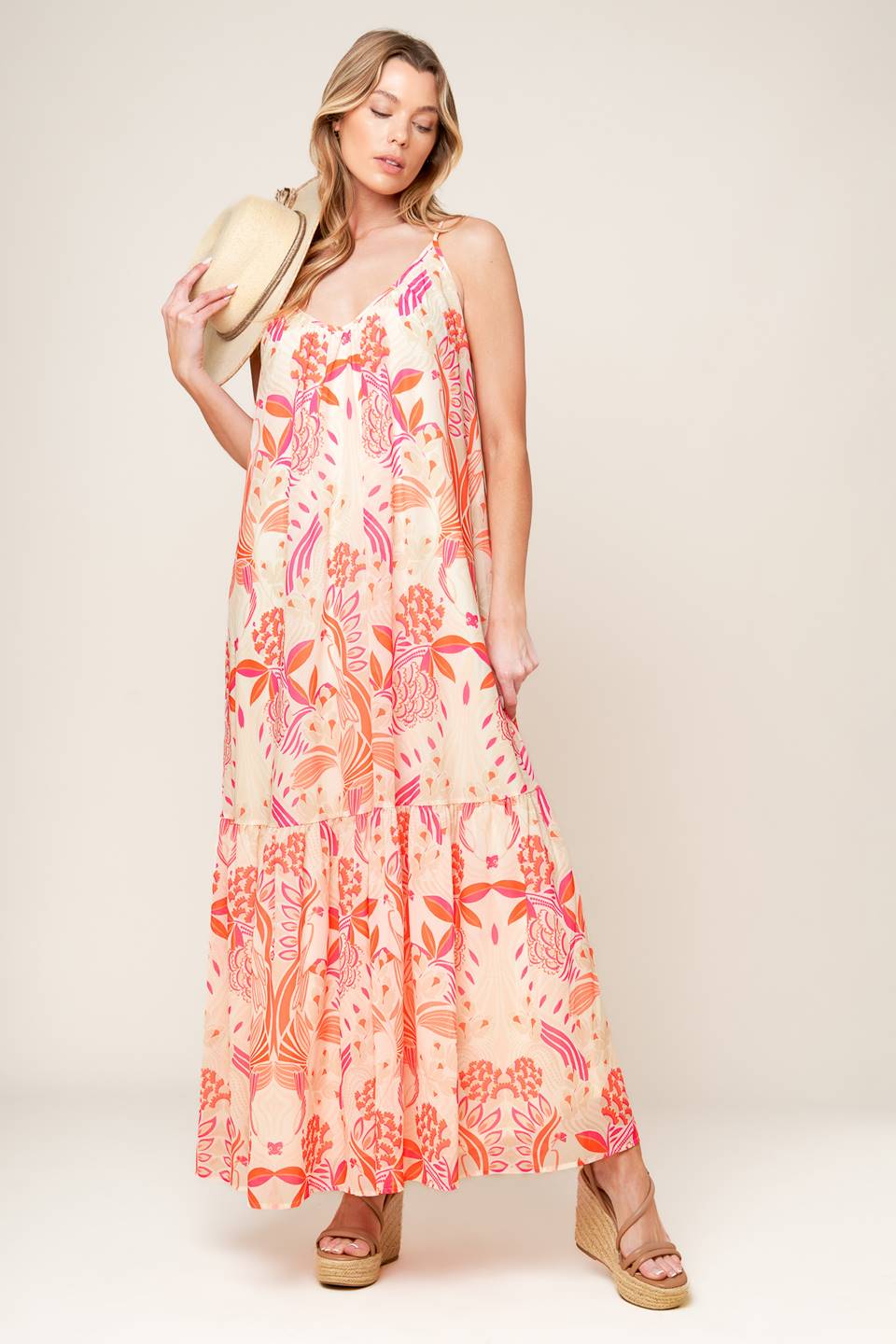 A printed woven maxi dress featuring cami dress featuring ruffled hemline and bare back with tie detail.