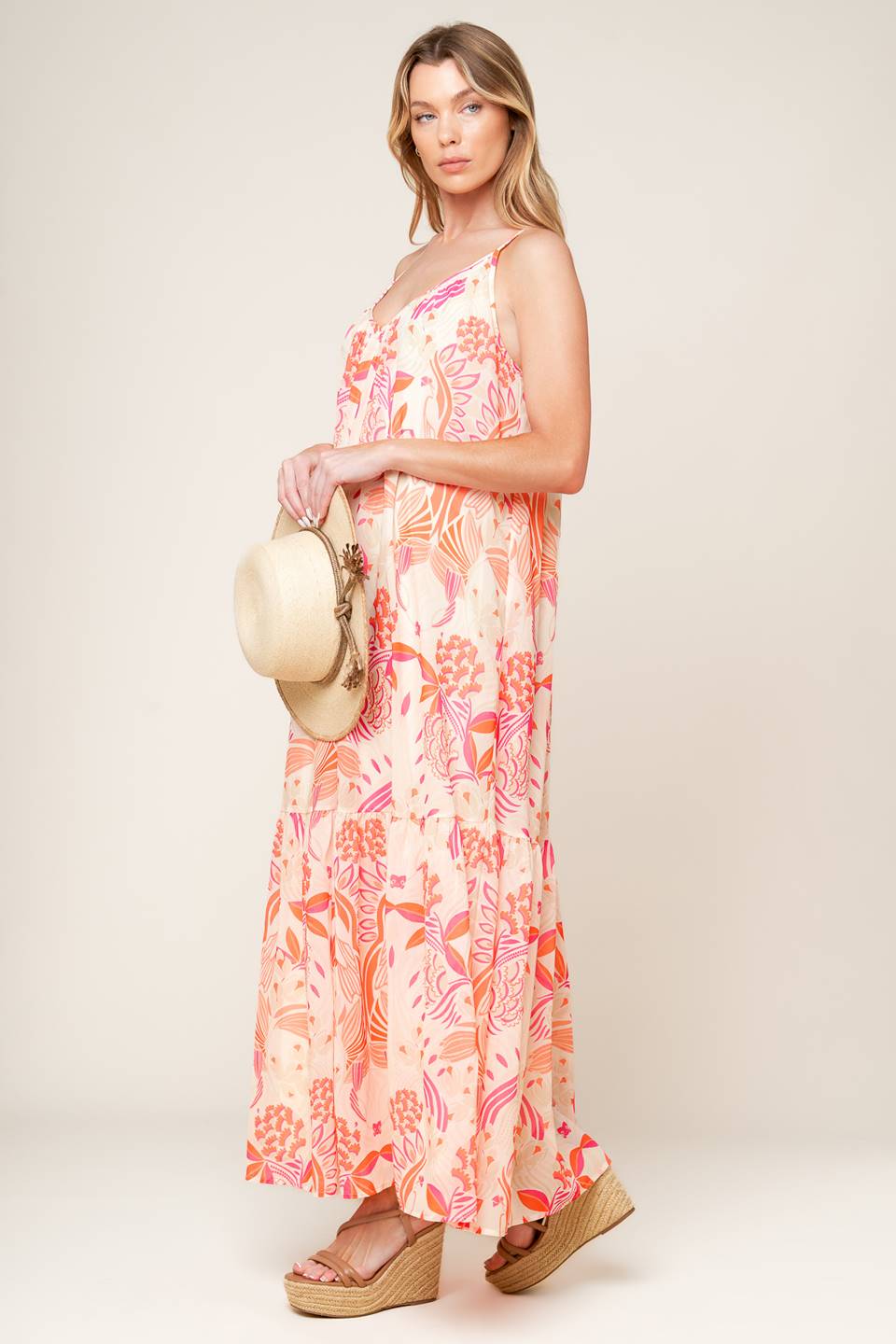 A printed woven maxi dress featuring cami dress featuring ruffled hemline and bare back with tie detail.