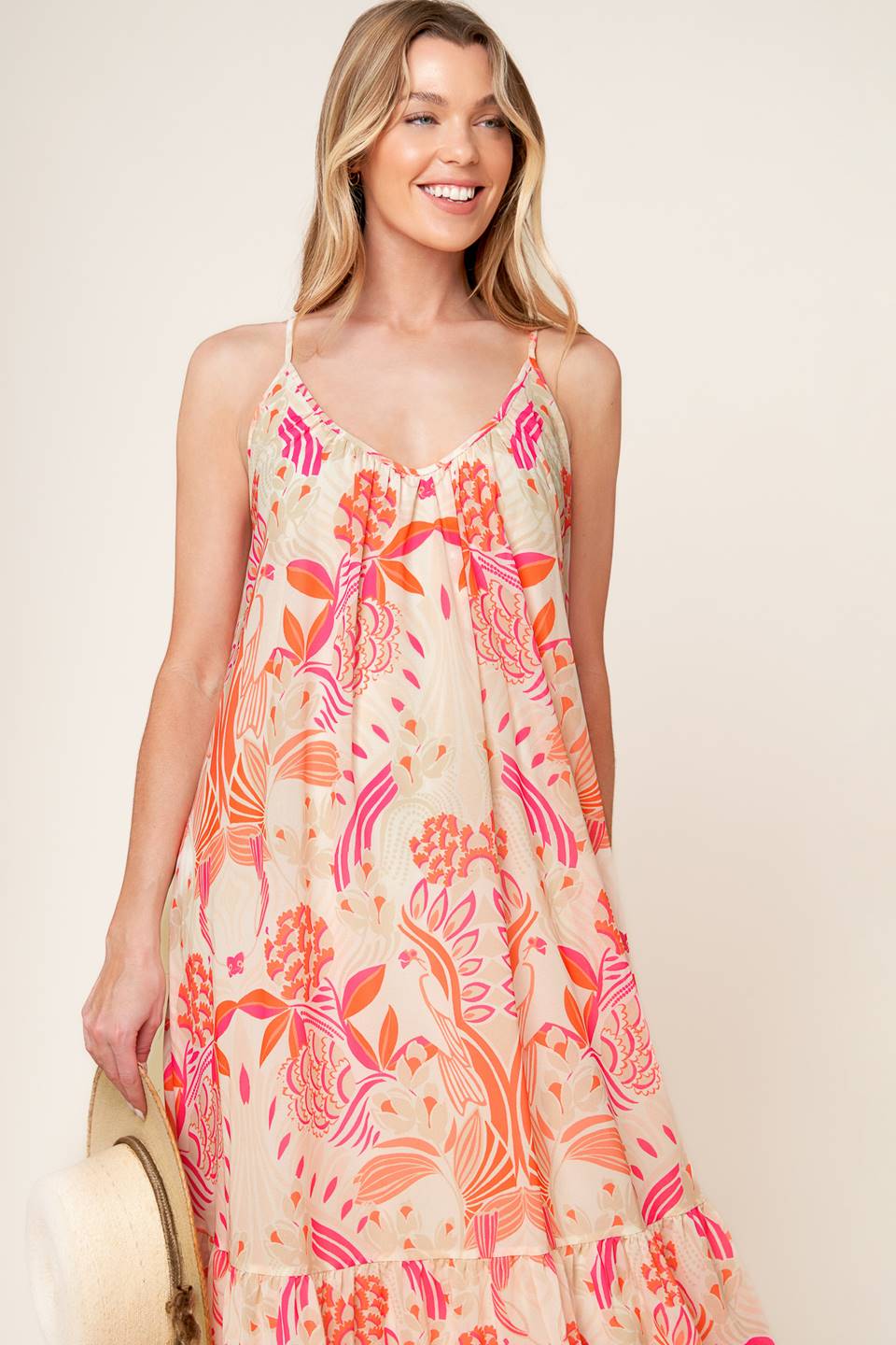 A printed woven maxi dress featuring cami dress featuring ruffled hemline and bare back with tie detail.