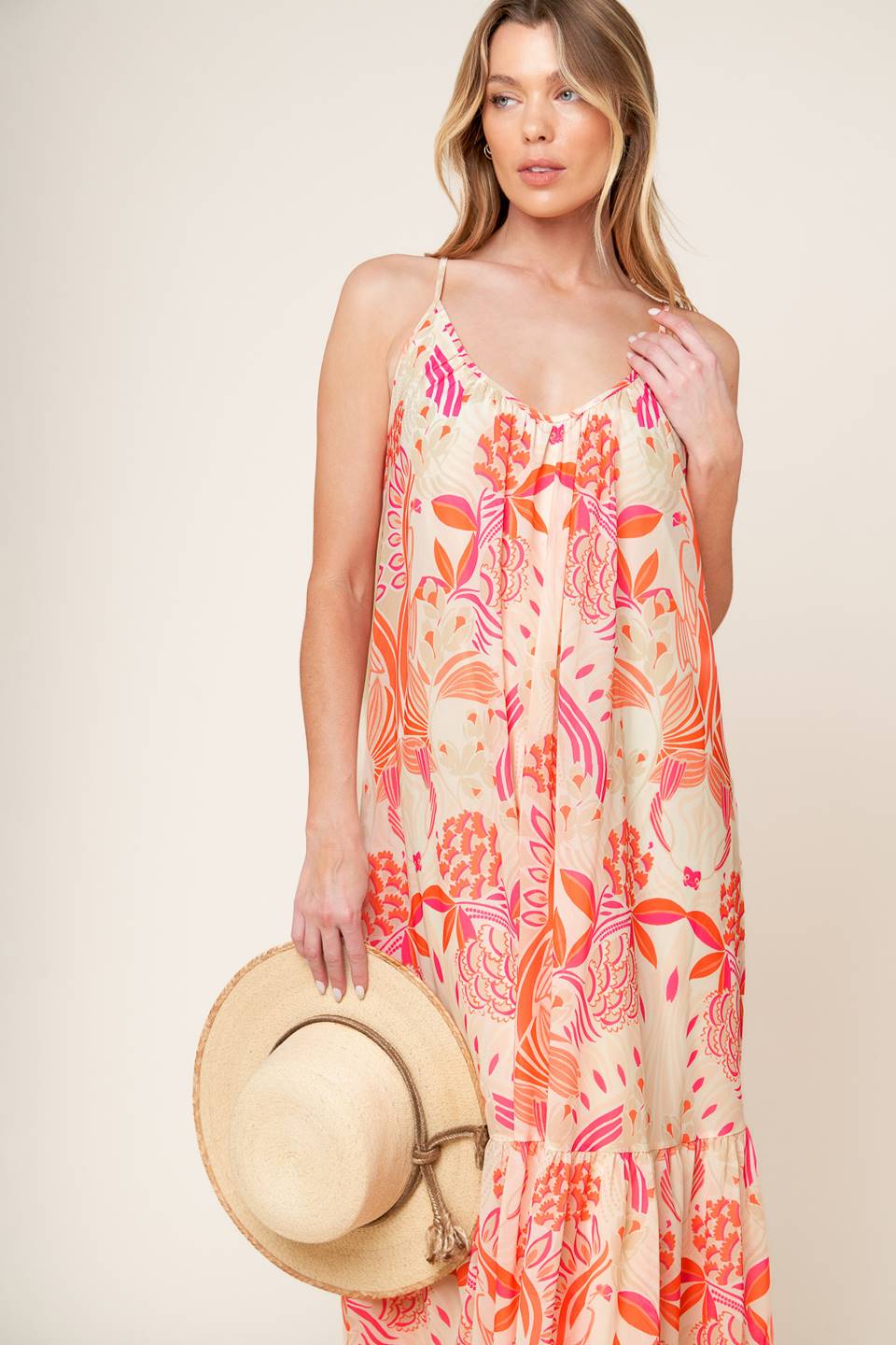 A printed woven maxi dress featuring cami dress featuring ruffled hemline and bare back with tie detail.