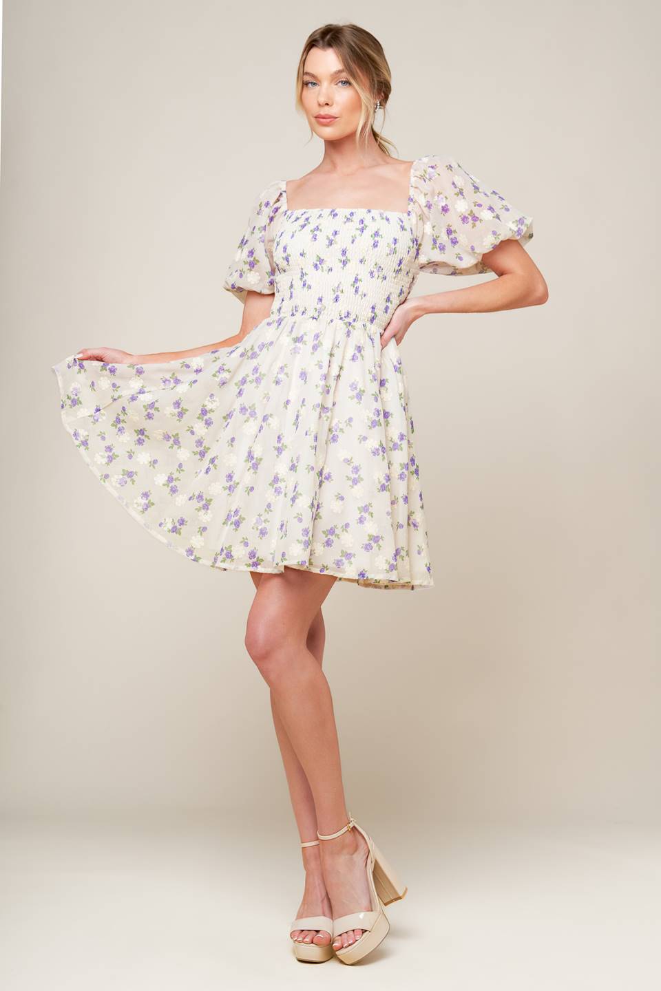 A floral texture printed woven mini dress featuring square neckline, short puff sleeve and full skirt.