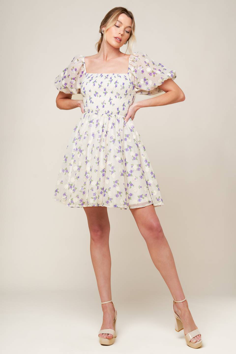 A floral texture printed woven mini dress featuring square neckline, short puff sleeve and full skirt.